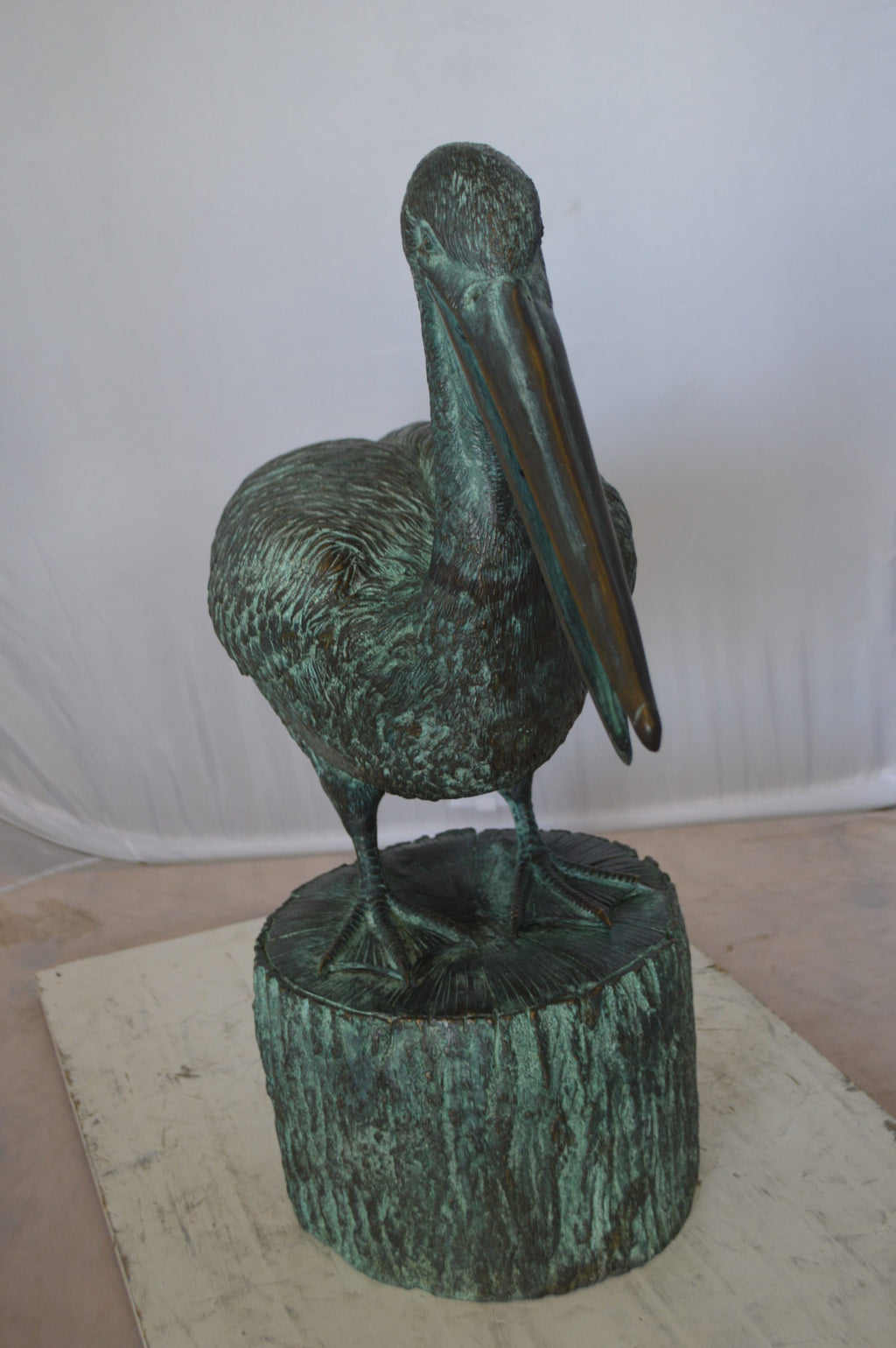 Nifao Pelican on a Tree Stump fountain bronze statue - Size: 30"L x 16"W x 46"H.