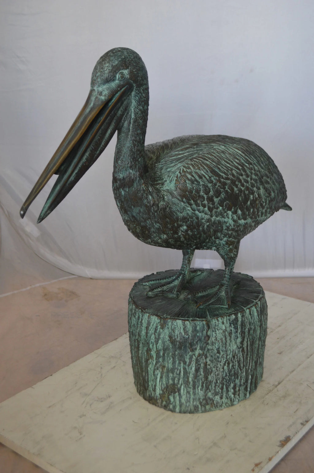 Nifao Pelican on a Tree Stump fountain bronze statue - Size: 30"L x 16"W x 46"H.