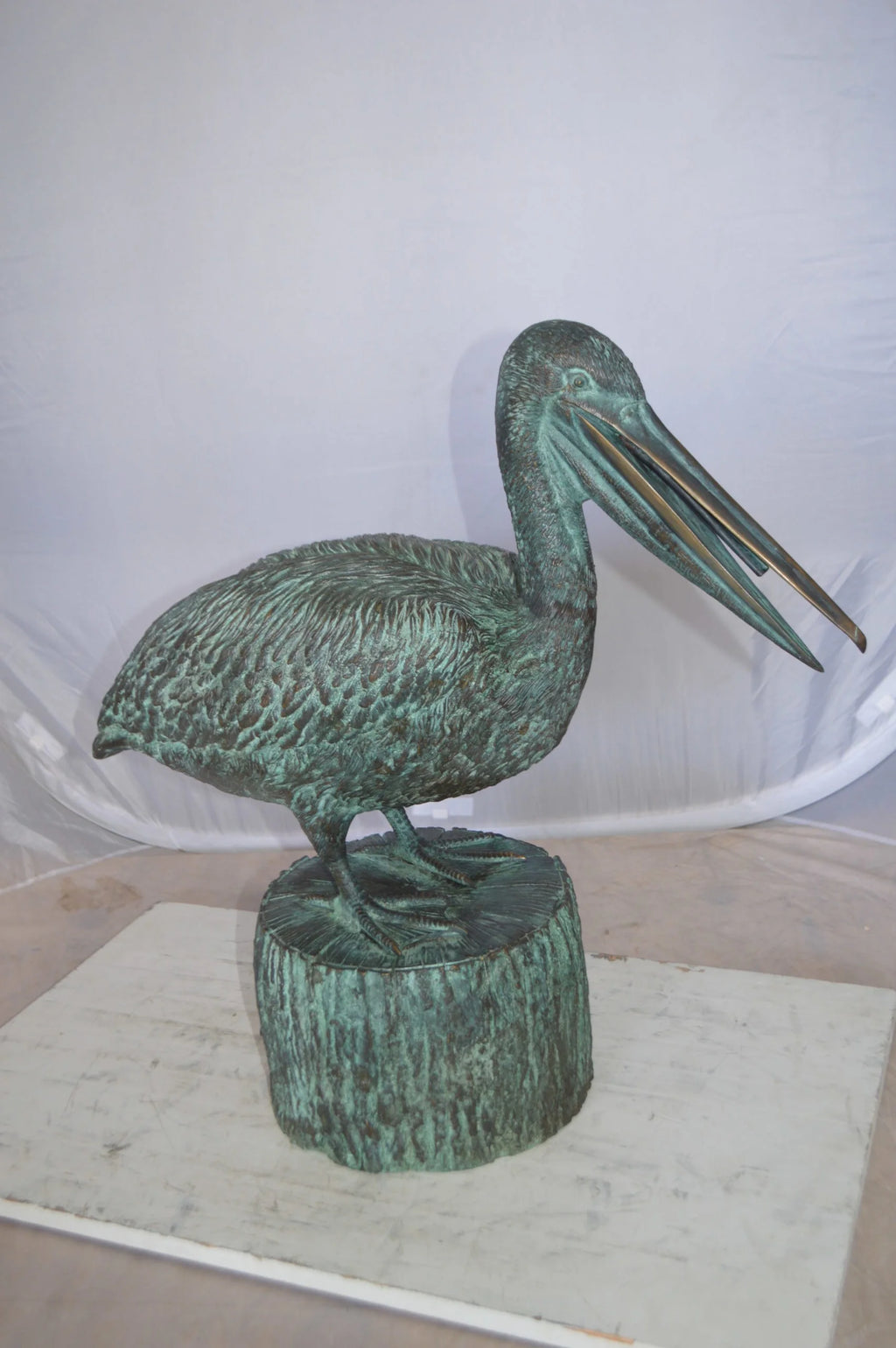 Nifao Pelican on a Tree Stump fountain bronze statue - Size: 30"L x 16"W x 46"H.