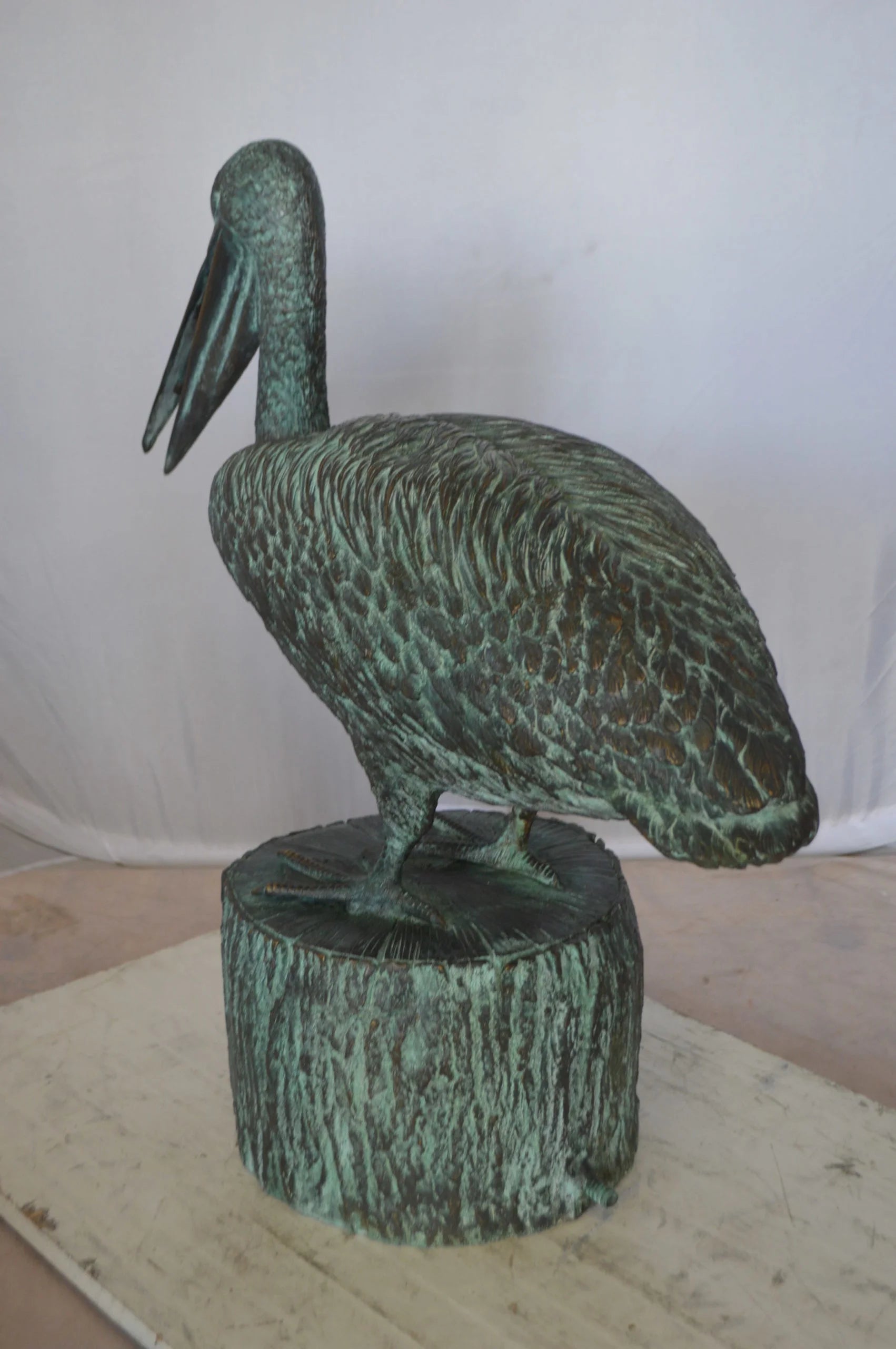 Nifao Pelican on a Tree Stump fountain bronze statue - Size: 30"L x 16"W x 46"H.