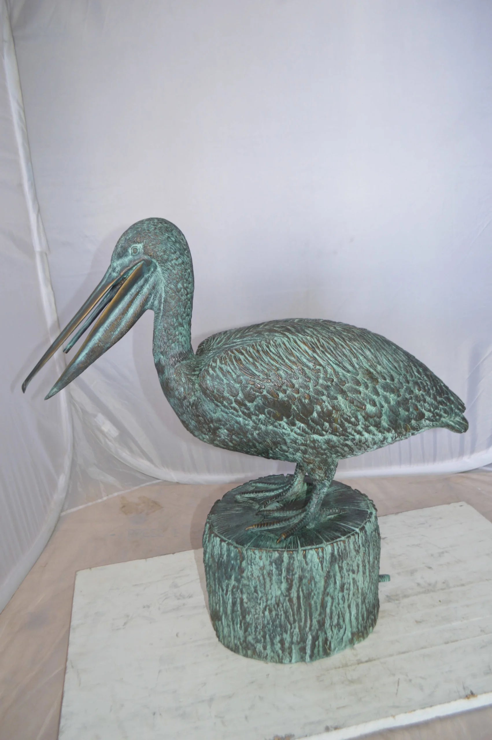 Nifao Pelican on a Tree Stump fountain bronze statue - Size: 30"L x 16"W x 46"H.